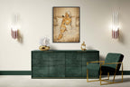 Modern interior with a green sideboard, gold chair, and wall art.